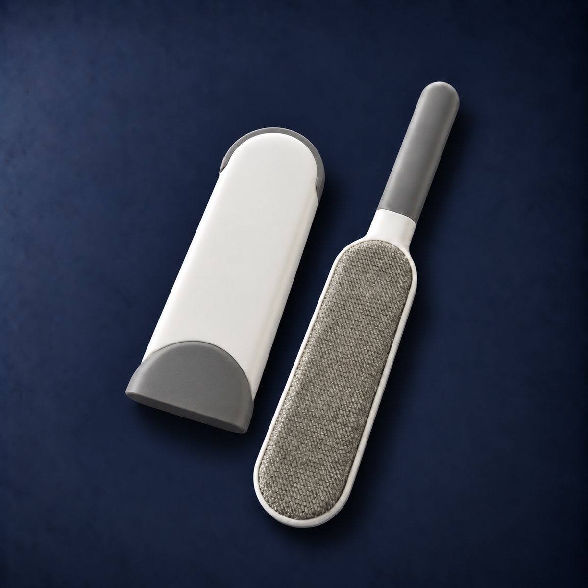 Lissaire Lint Remover Brush with its white storage case on a navy background